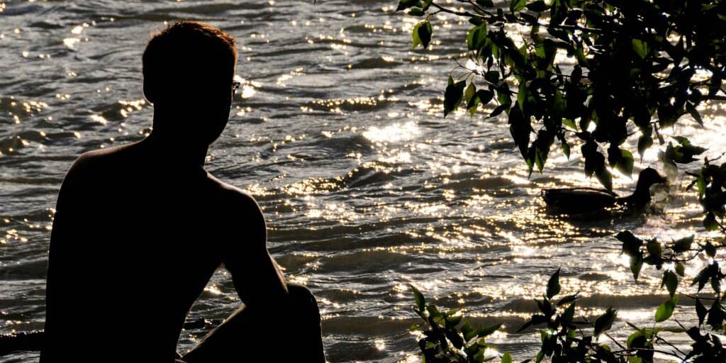 man sitting at water abdominal breathing