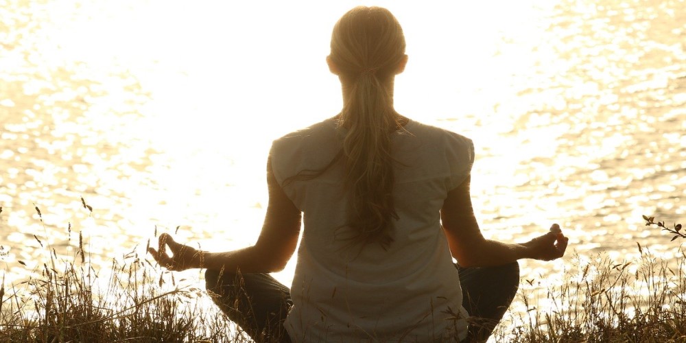 woman meditating breathing exercises to manage stress