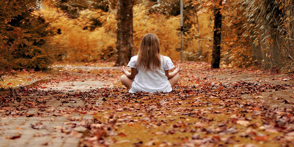 woman meditating in autumn spiritual practices for autumn